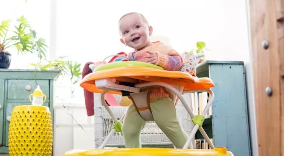 Baby girl playing in walker